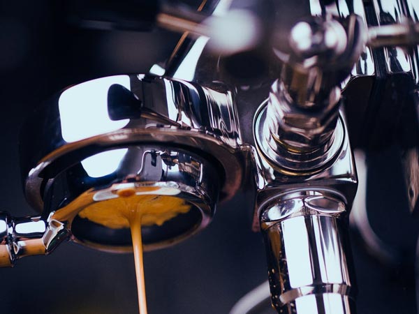 A photo of a coffee machine pouring coffee in a cup