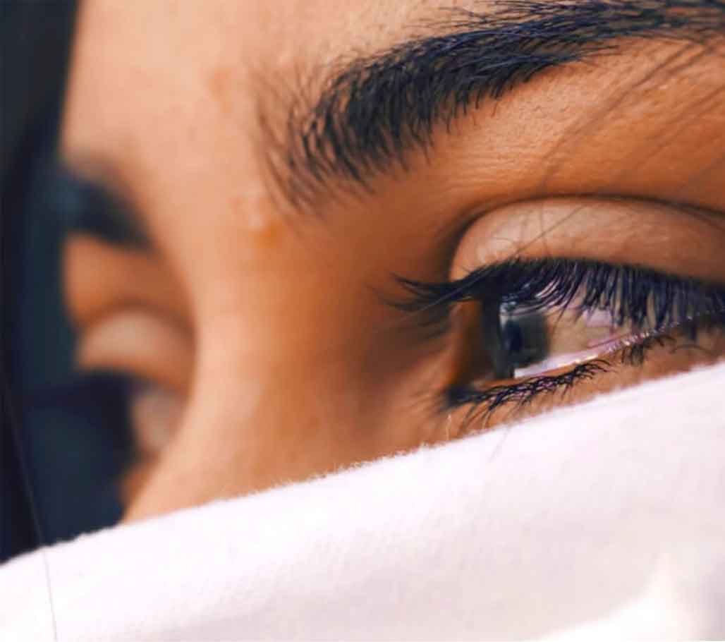 An image of a teary-eyed woman.