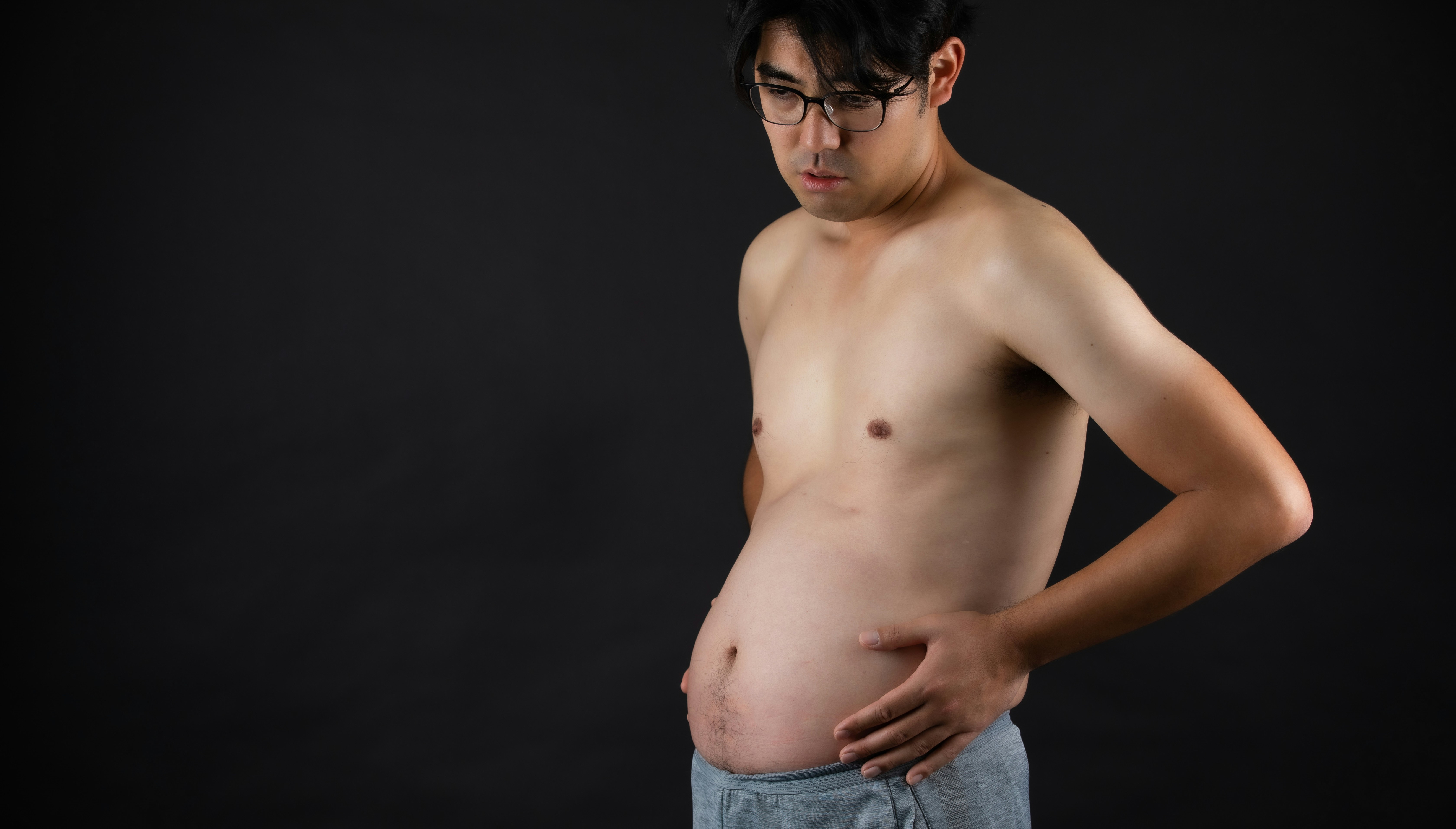 A man with a visible dad bod