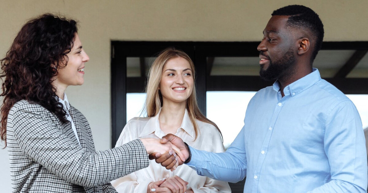 A woman introducing two people as potential partners, a practice found in the history of matchmaking.