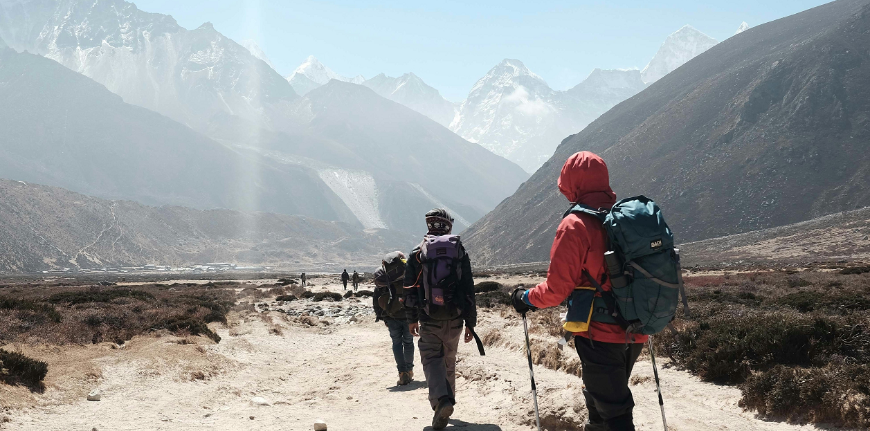 Several people traveling around the rural mountainside.